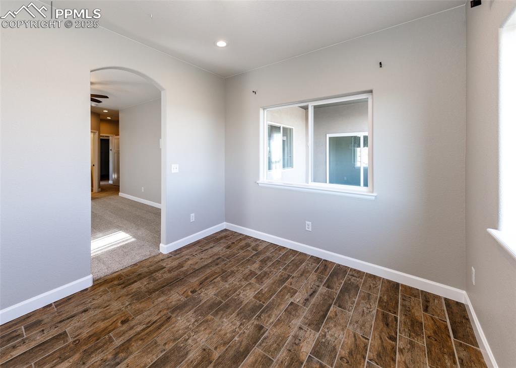 2105 Slocum Road Peyton, CO 80831 - Photo 18 of 27 a view of an empty room with wooden floor and a window