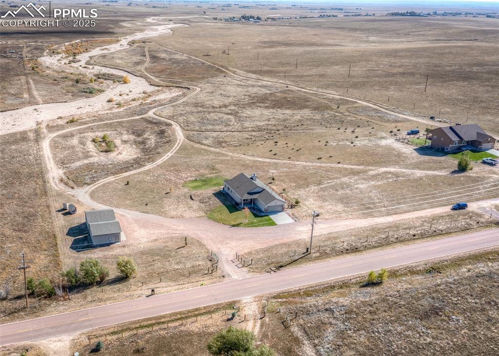 2105 Slocum Road Peyton, CO 80831 - Photo 27 of 27 a white bench sitting in front of a house
