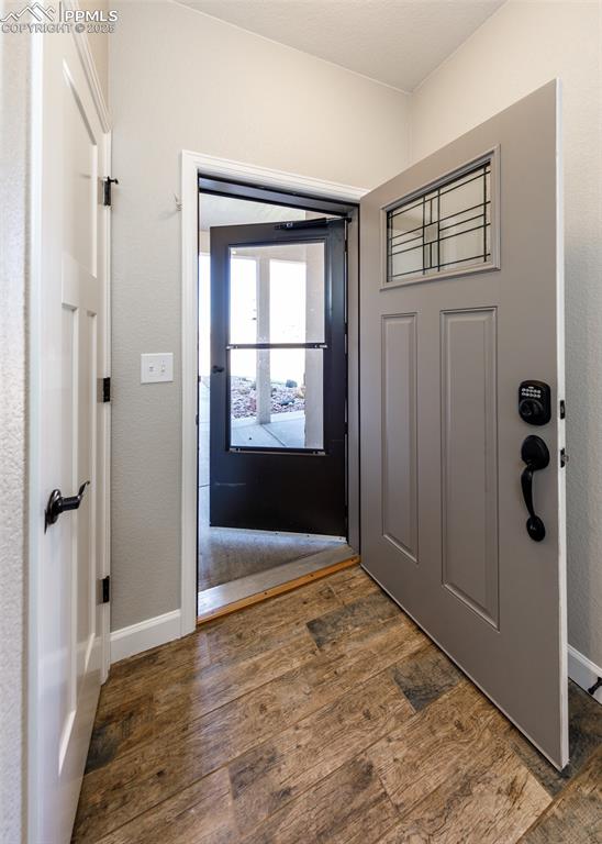 2105 Slocum Road Peyton, CO 80831 - Photo 5 of 27 a view of an empty room with wooden floor and a window