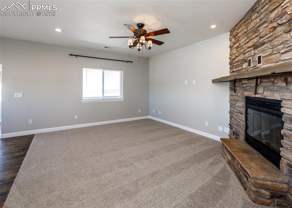 2105 Slocum Road Peyton, CO 80831 - Photo 7 of 27 an empty room with windows and ceiling fan