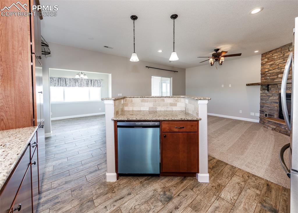 2105 Slocum Road Peyton, CO 80831 - Photo 9 of 27 a kitchen with kitchen island a counter top space a sink appliances and cabinets