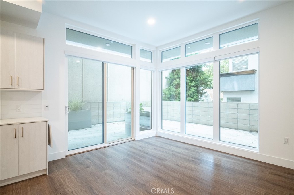 709 East Walnut, Unit 219 Pasadena, CA 91109 - Photo 15 of 38 a view of an empty room with wooden floor and a window