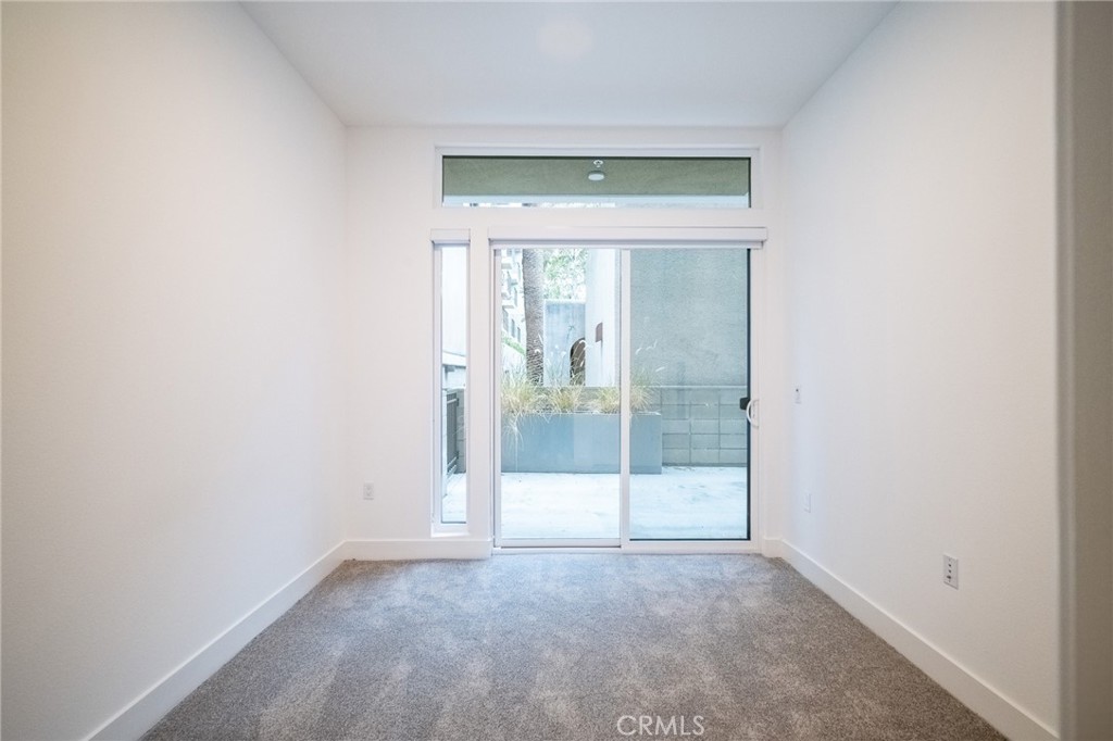 709 East Walnut, Unit 219 Pasadena, CA 91109 - Photo 19 of 38 an empty room with sliding glass door and shower