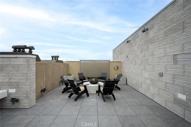 a terrace with outdoor seating and city view