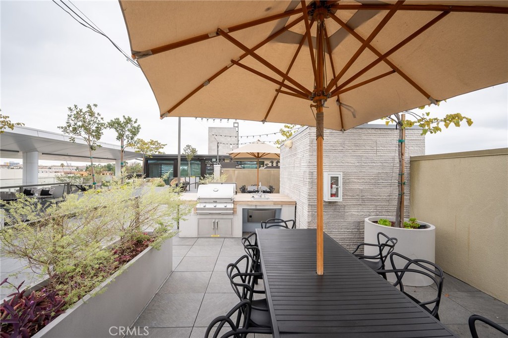 709 East Walnut, Unit 219 Pasadena, CA 91109 - Photo 29 of 38 a view of balcony with furniture and umbrella