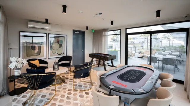 a living room with furniture and a floor to ceiling window