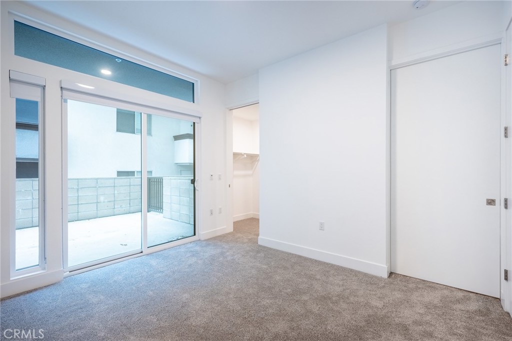 709 East Walnut, Unit 219 Pasadena, CA 91109 - Photo 8 of 38 a view of an empty room with glass door
