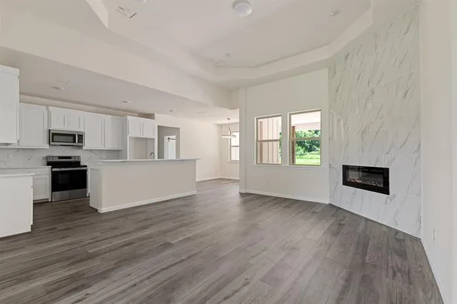 a view of a kitchen with microwave and stove top oven