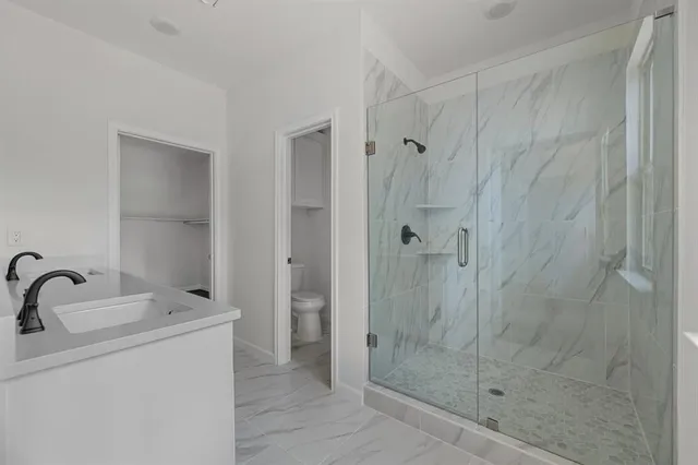 a bathroom with a shower and sink
