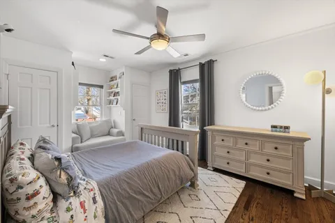 a bedroom with a bed a window and a chandelier