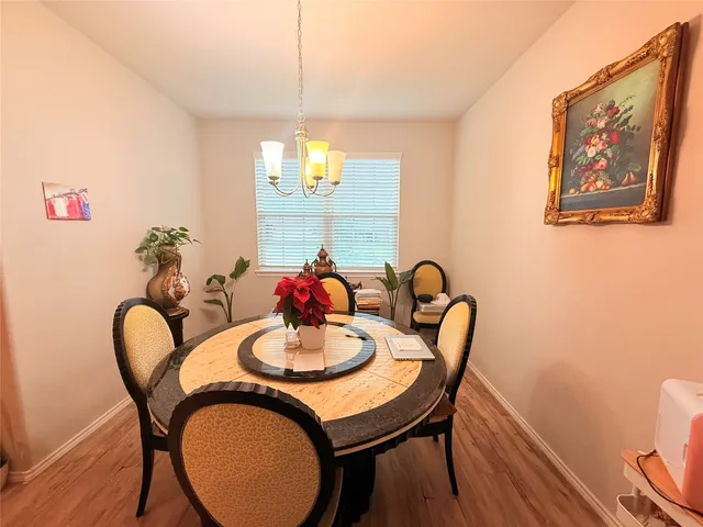 a dining room with furniture and wooden floor