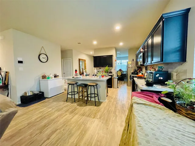 a living room with furniture and kitchen view