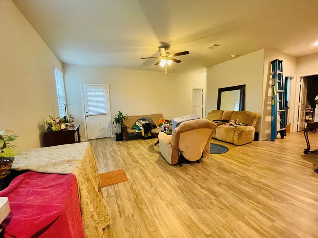 a bed room with a bed mirror and a lamp