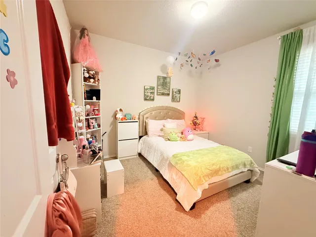 a bedroom with double bed and a window