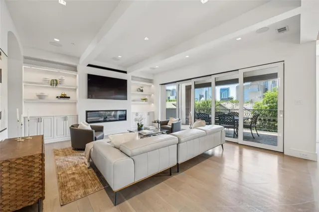 a living room with fireplace furniture and a flat screen tv