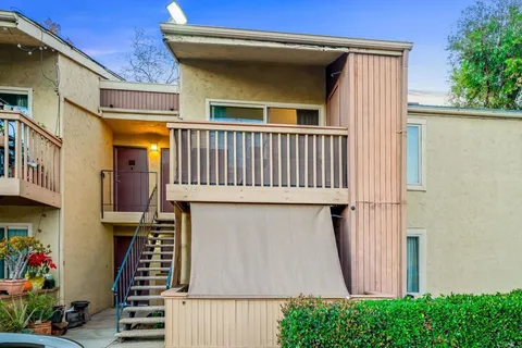 a front view of a house with plants and entryway