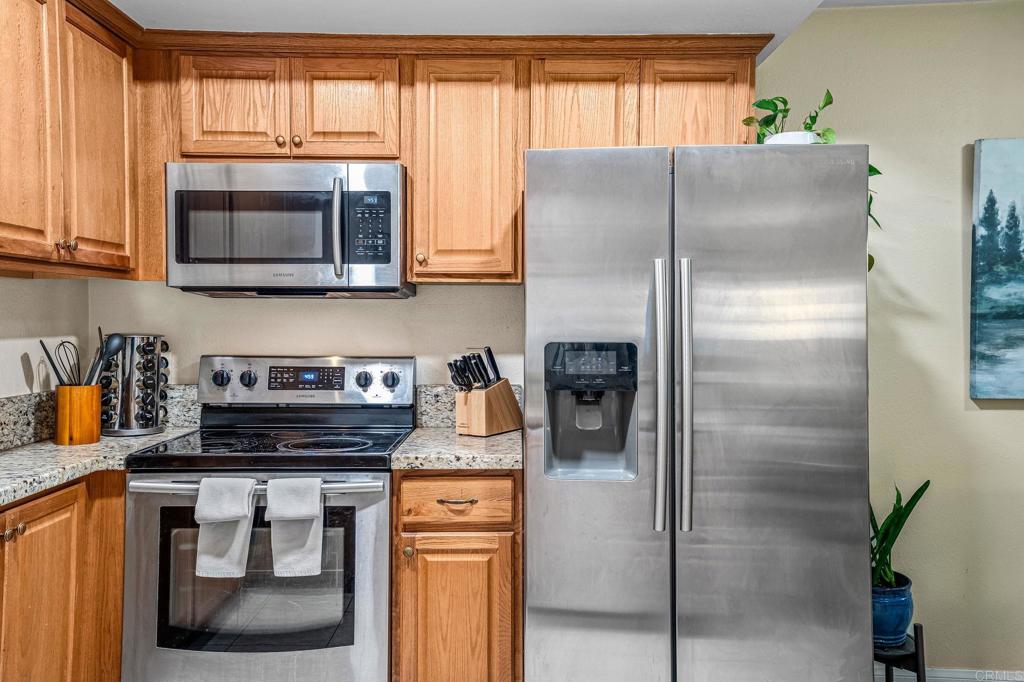 5922 Rancho Mission Road, Unit 78 San Diego, CA 92108 - Photo 11 of 25 a kitchen with a refrigerator and a stove