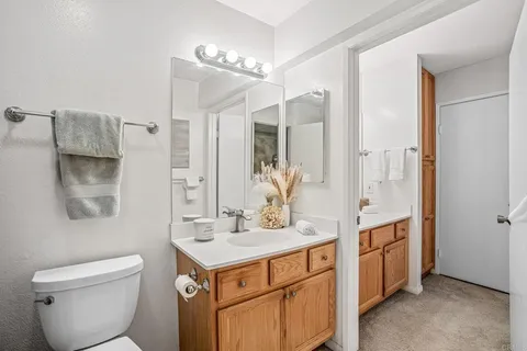 a bathroom with a toilet sink and mirror