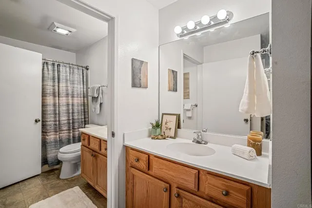 a bathroom with a sink toilet double vanity and shower