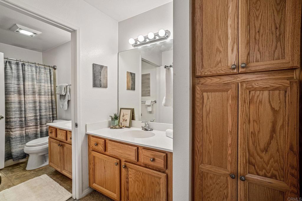 5922 Rancho Mission Road, Unit 78 San Diego, CA 92108 - Photo 15 of 25 a bathroom with a sink a toilet and shower