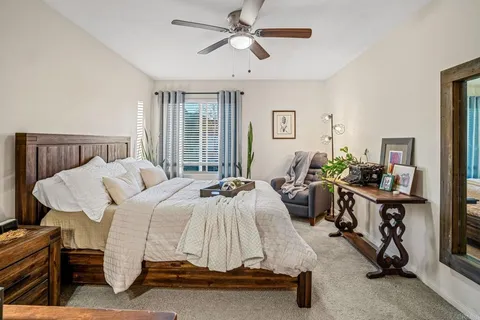 a bedroom with furniture a bed and a chandelier