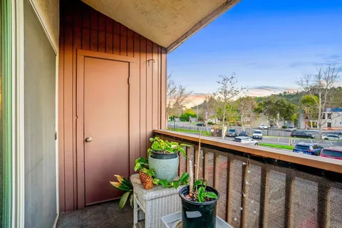a city view from a balcony with chairs