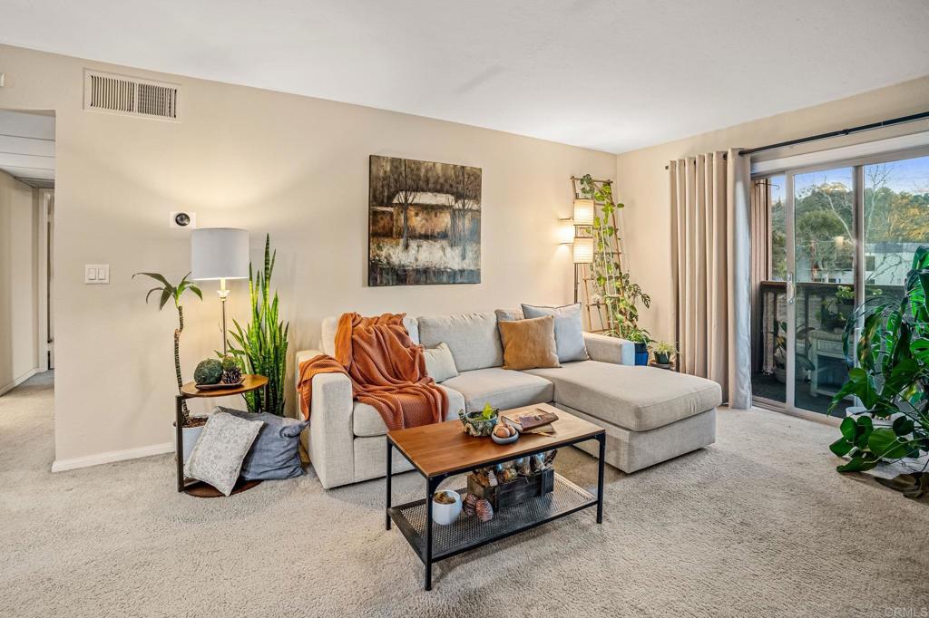 5922 Rancho Mission Road, Unit 78 San Diego, CA 92108 - Photo 3 of 25 a living room with furniture and a large window