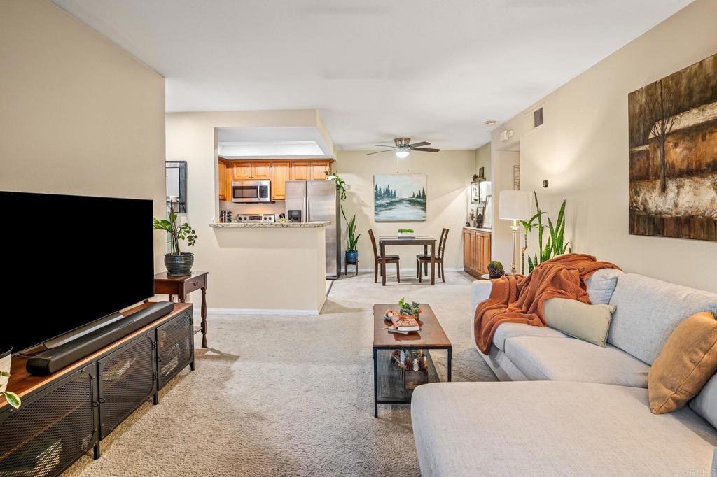 5922 Rancho Mission Road, Unit 78 San Diego, CA 92108 - Photo 6 of 25 a living room with furniture and a flat screen tv