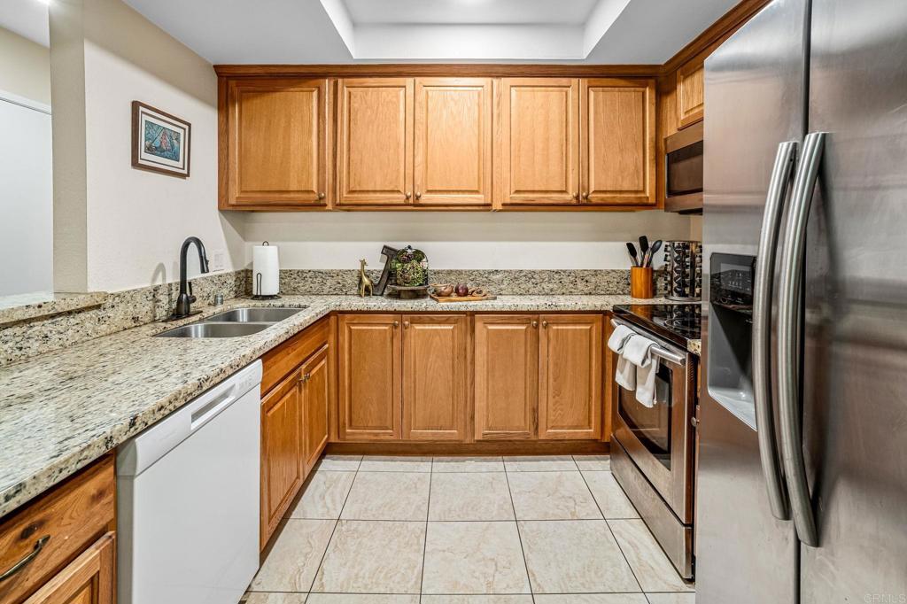 5922 Rancho Mission Road, Unit 78 San Diego, CA 92108 - Photo 10 of 25 a kitchen with a sink stove and refrigerator