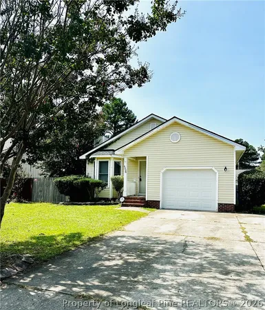 a view of a house with a big yard and large trees