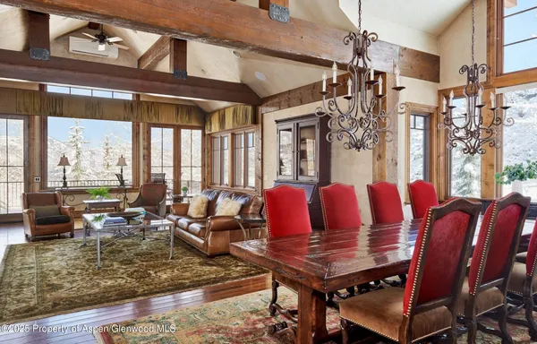 a view of a dining room with furniture large windows and wooden floor