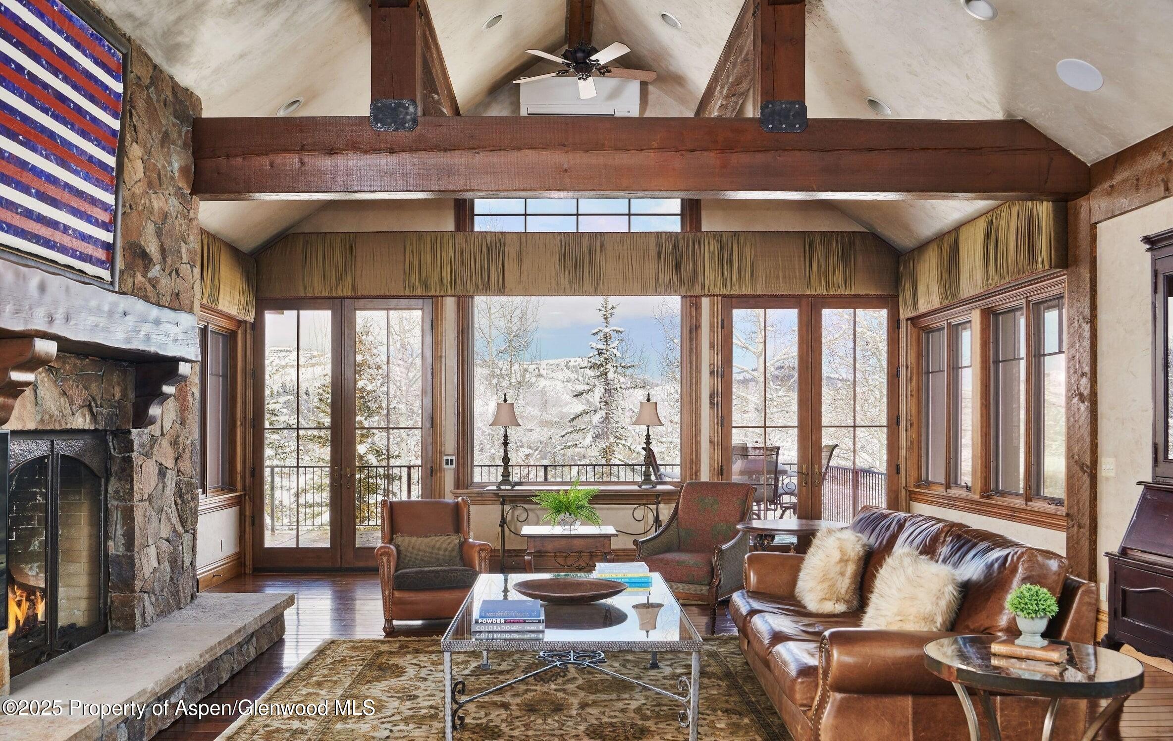 64 Spruce Ridge Lane Snowmass Village, CO 81615 - Photo 13 of 38 a living room with furniture and a floor to ceiling window