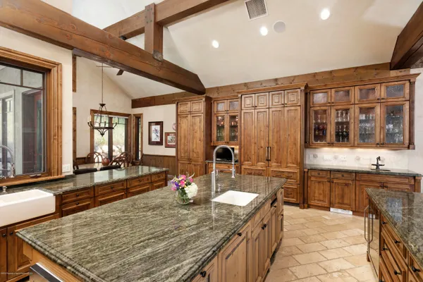 a kitchen with sink stove and dining table
