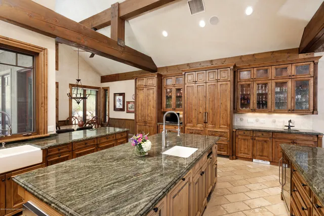 a view of a patio with table and chairs under an umbrella