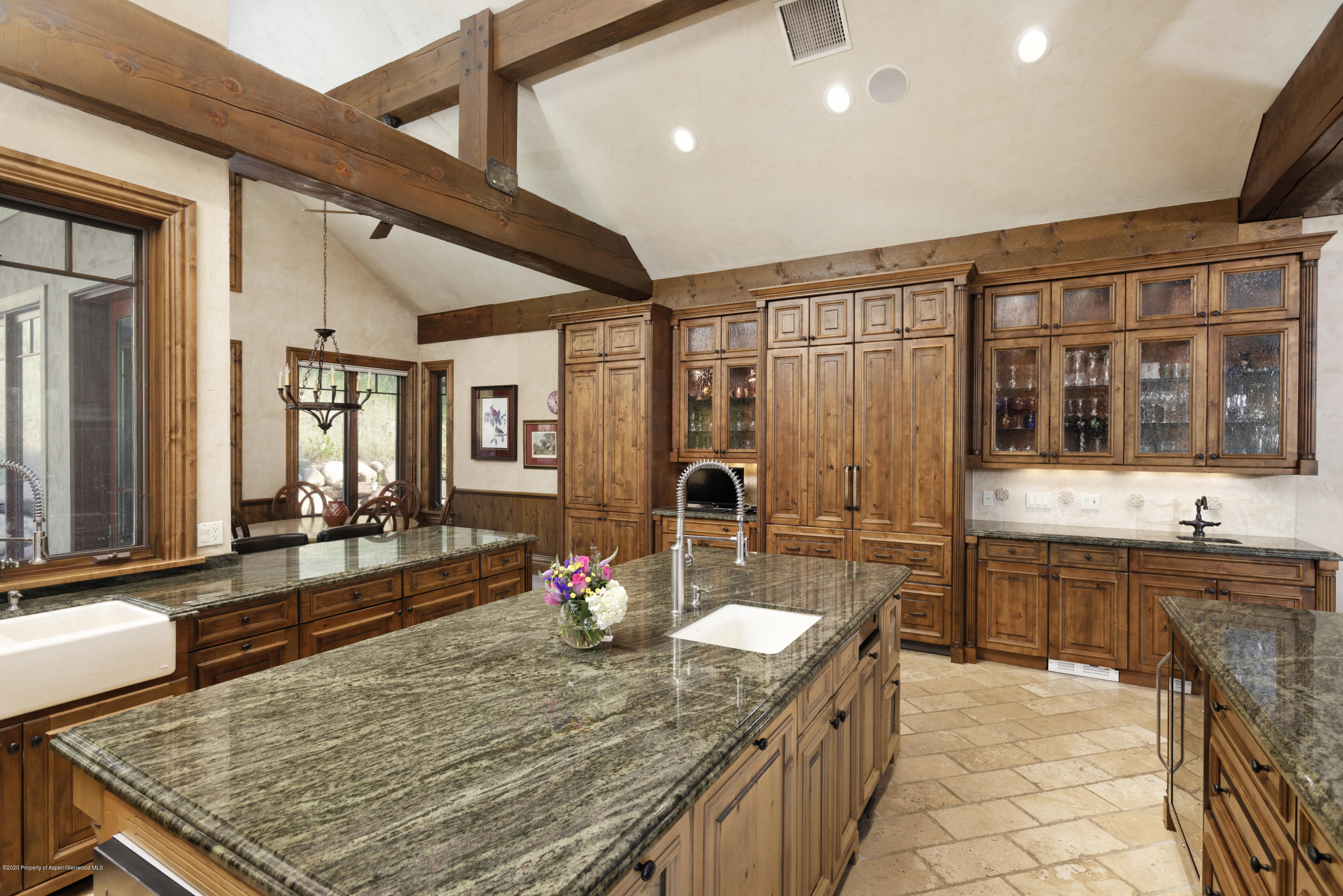 64 Spruce Ridge Lane Snowmass Village, CO 81615 - Photo 16 of 38 a kitchen with sink stove and dining table
