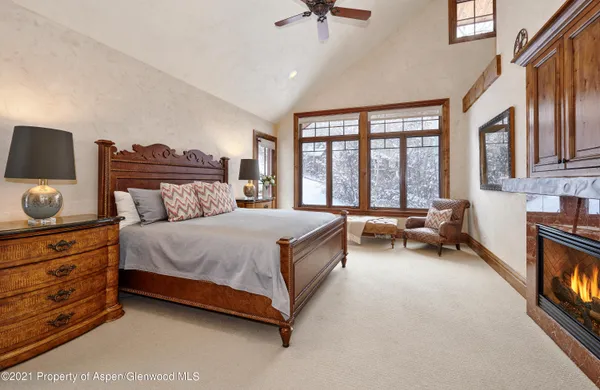 a spacious bedroom with a bed couch and a large window