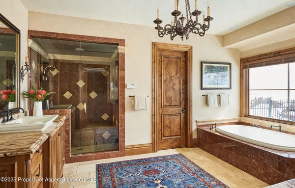 a spacious bathroom with a granite countertop tub sink and mirror