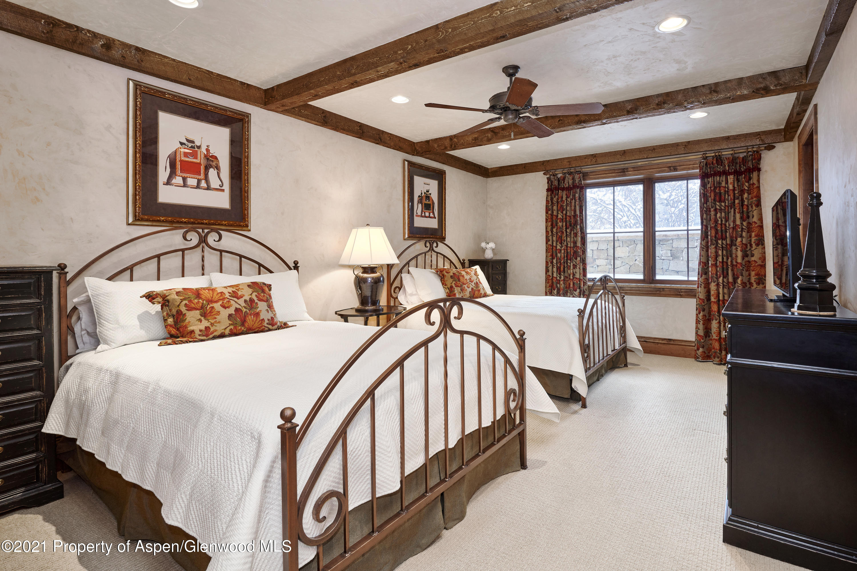 64 Spruce Ridge Lane Snowmass Village, CO 81615 - Photo 23 of 38 a bedroom with a bed a couch and a large window