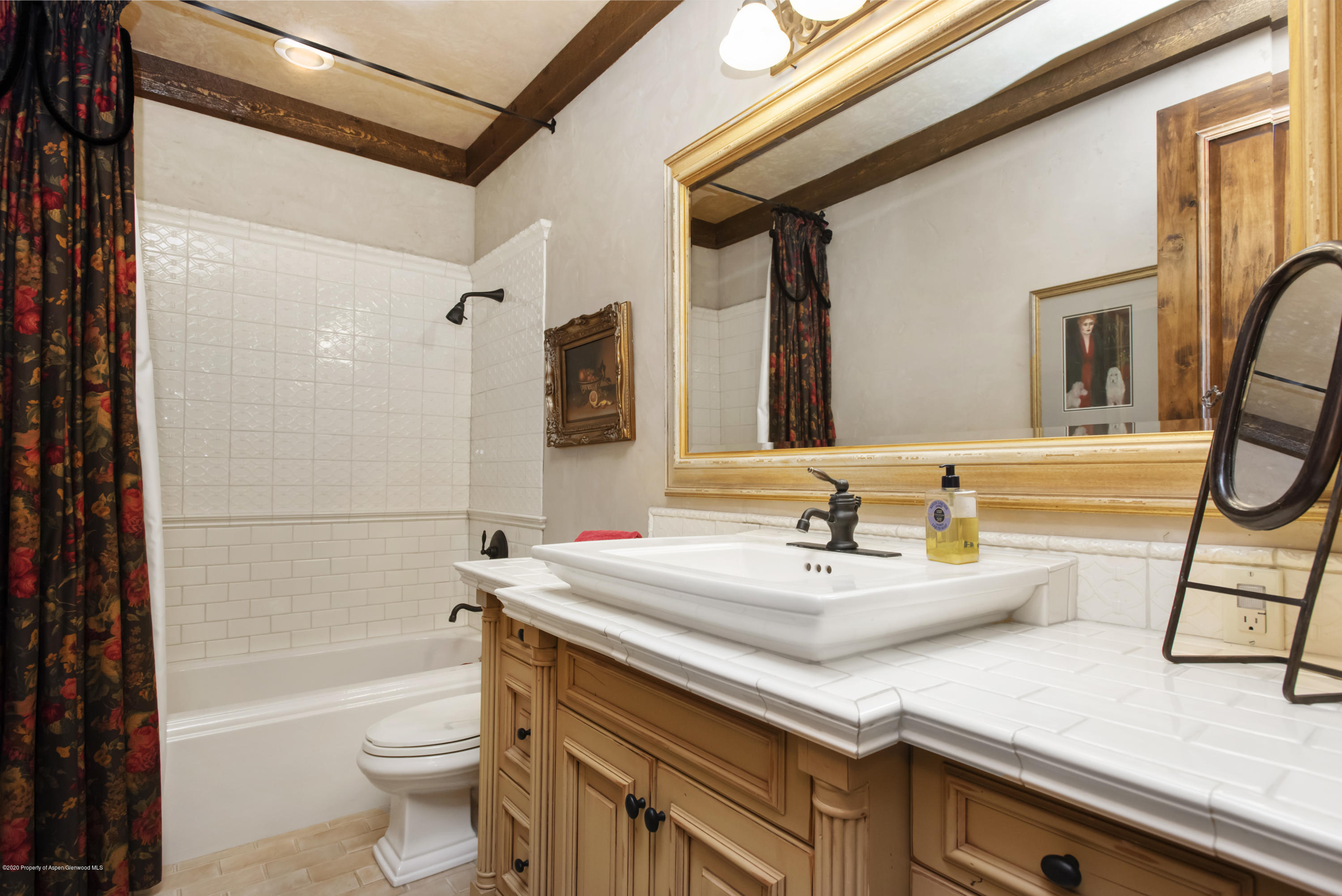 64 Spruce Ridge Lane Snowmass Village, CO 81615 - Photo 24 of 38 a bathroom with a sink a toilet a mirror and shower