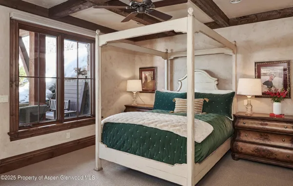 a bedroom with a bed a large window with outer view