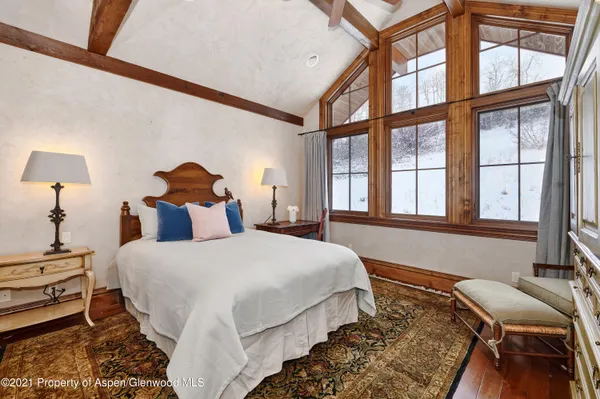 a bedroom with a bed and a large window
