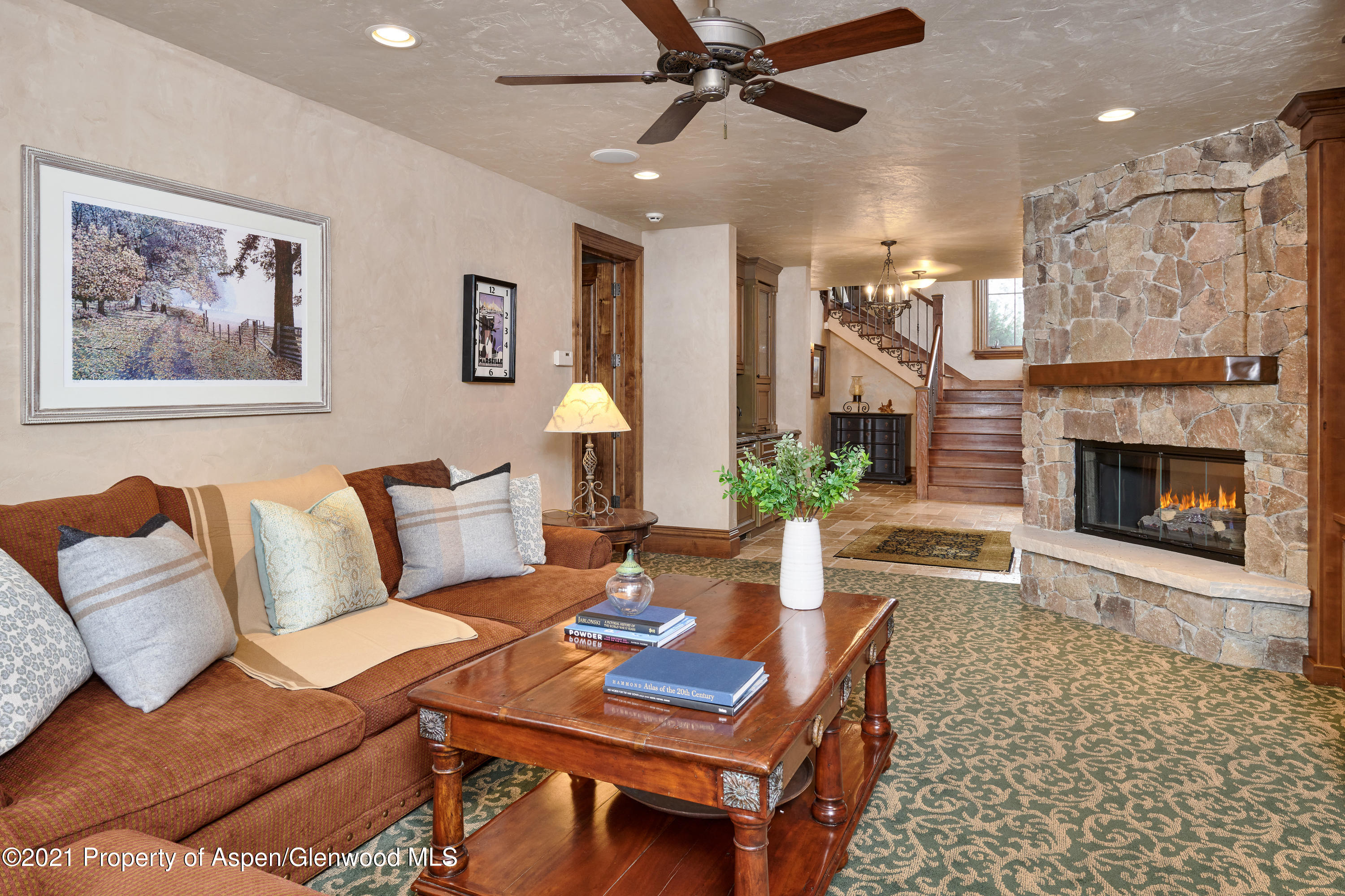 64 Spruce Ridge Lane Snowmass Village, CO 81615 - Photo 28 of 38 a living room with furniture and a fireplace