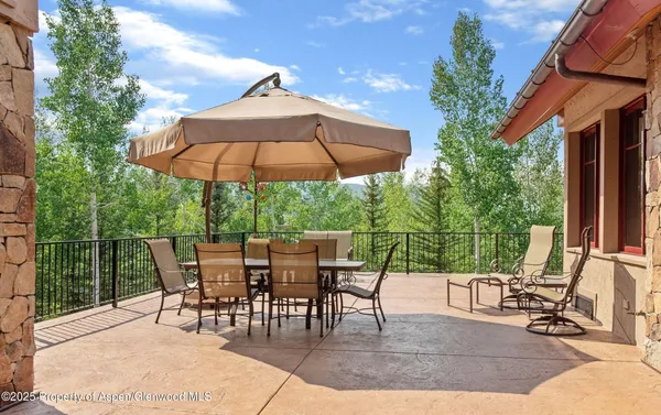 a view of a backyard with furniture and a garden
