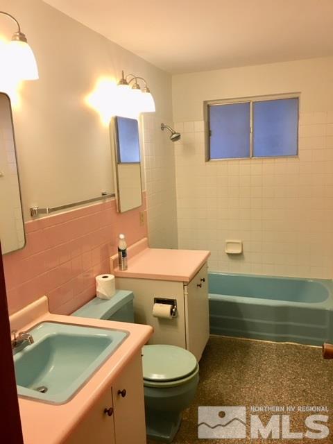2035 West 6th Street Reno, NV 89503 - Photo 10 of 15 a bathroom with a sink a toilet and mirror