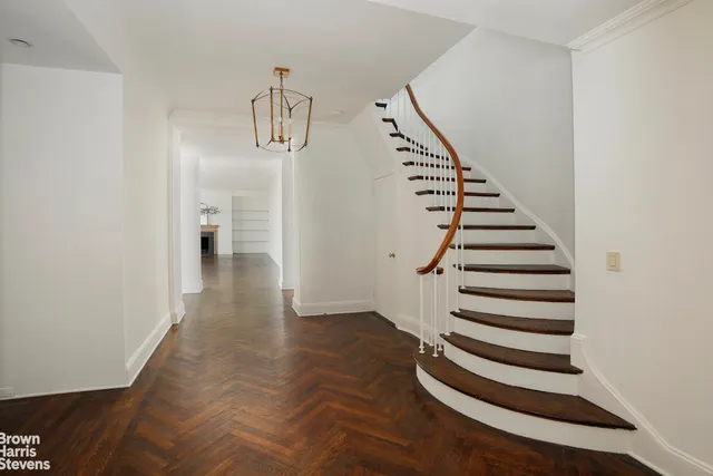 a view of entryway with stairs and wooden floor