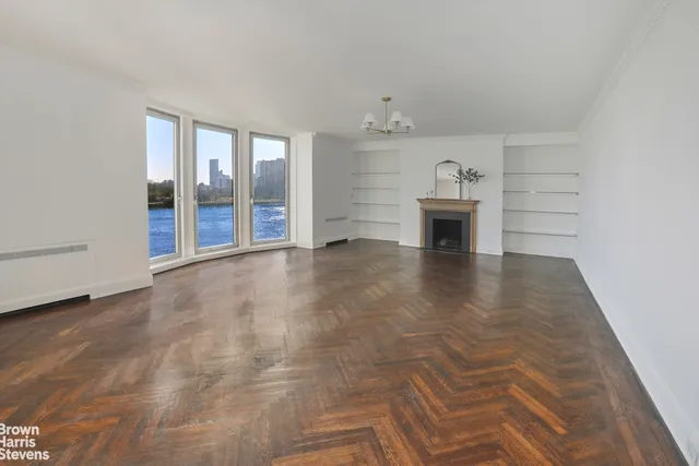 wooden floor in an empty room with a fireplace