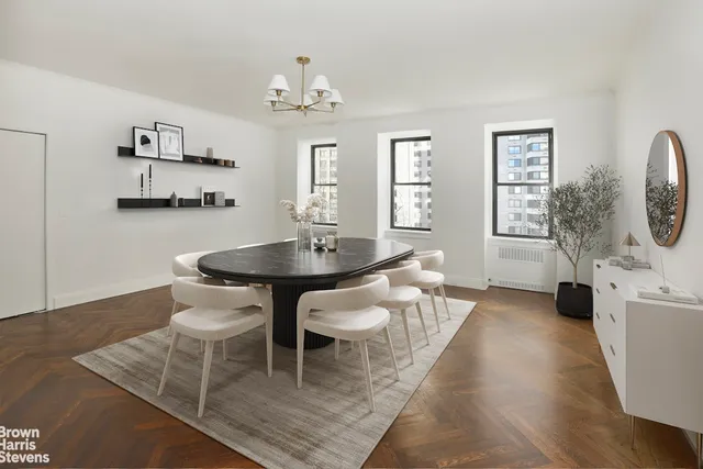 a view of a dining room with furniture and chandelier