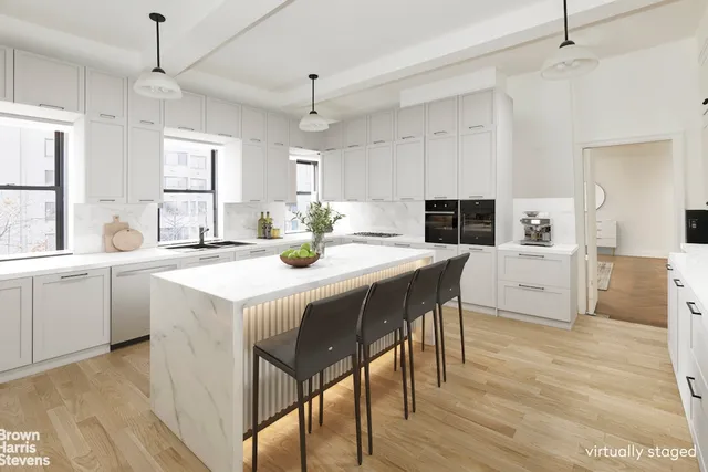 a kitchen with stainless steel appliances kitchen island granite countertop a table chairs and a refrigerator