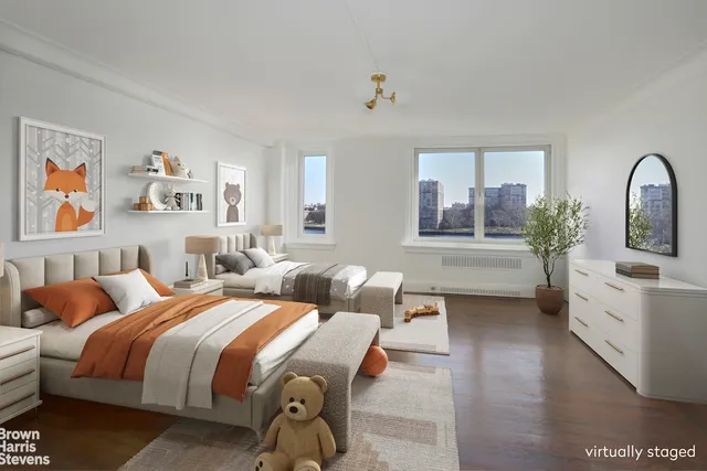 a spacious bedroom with a bed a couch and paintings on the wall