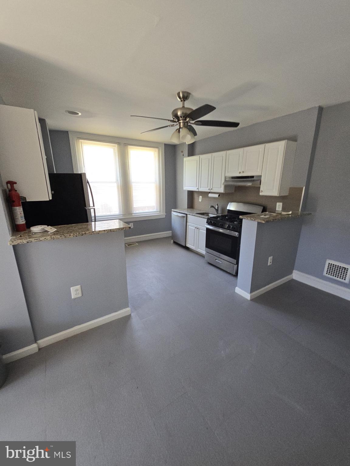 5314 Angora Terrace, Unit 1 Philadelphia, PA 19143 - Photo 12 of 15 a view of a kitchen with furniture and a ceiling fan